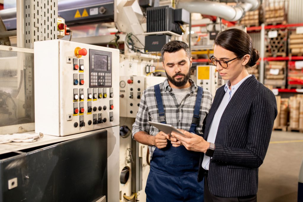 Young engineer and female business partner searching for technical data